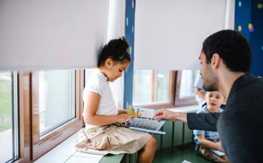 Registered behavior technician helping a child in the classroom