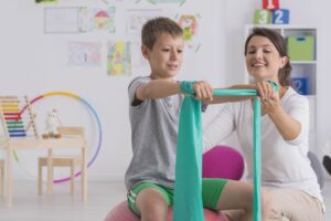 Pediatric physical therapist working with a student at school