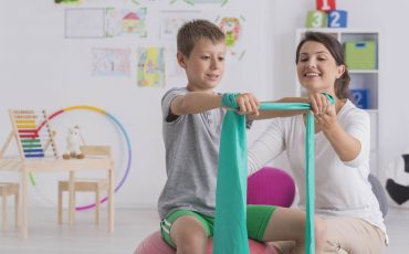 Pediatric physical therapist working with a student at school